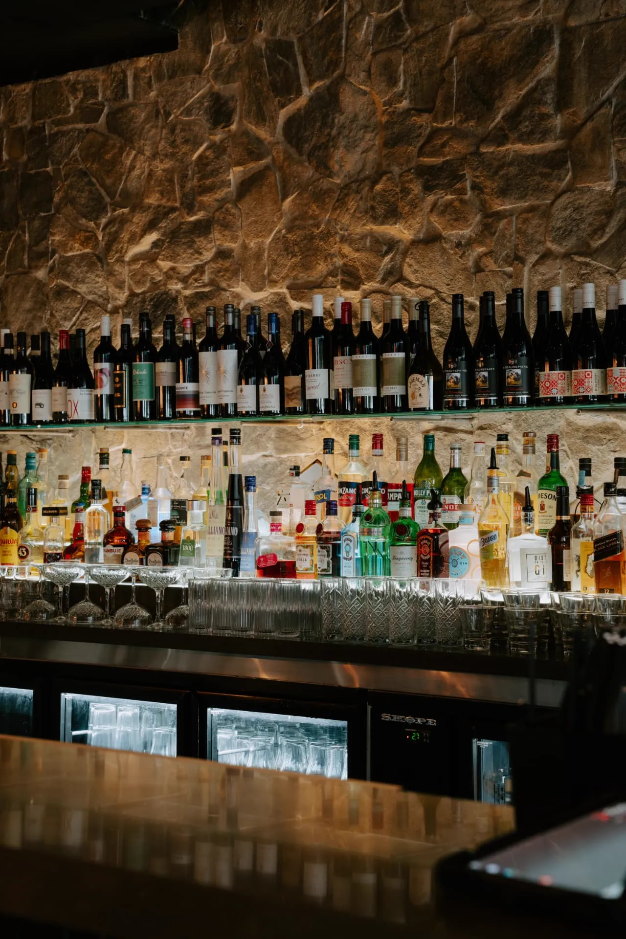 Fully stocked bar with wine and spirits at Waterbar & Grill Steakhouse, Cairns