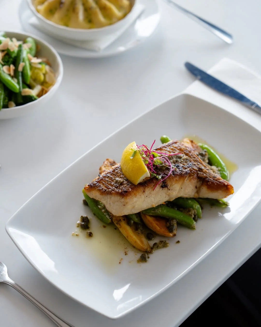 Pan-fried reef fish with greens and lemon at Waterbar & Grill Steakhouse, Cairns
