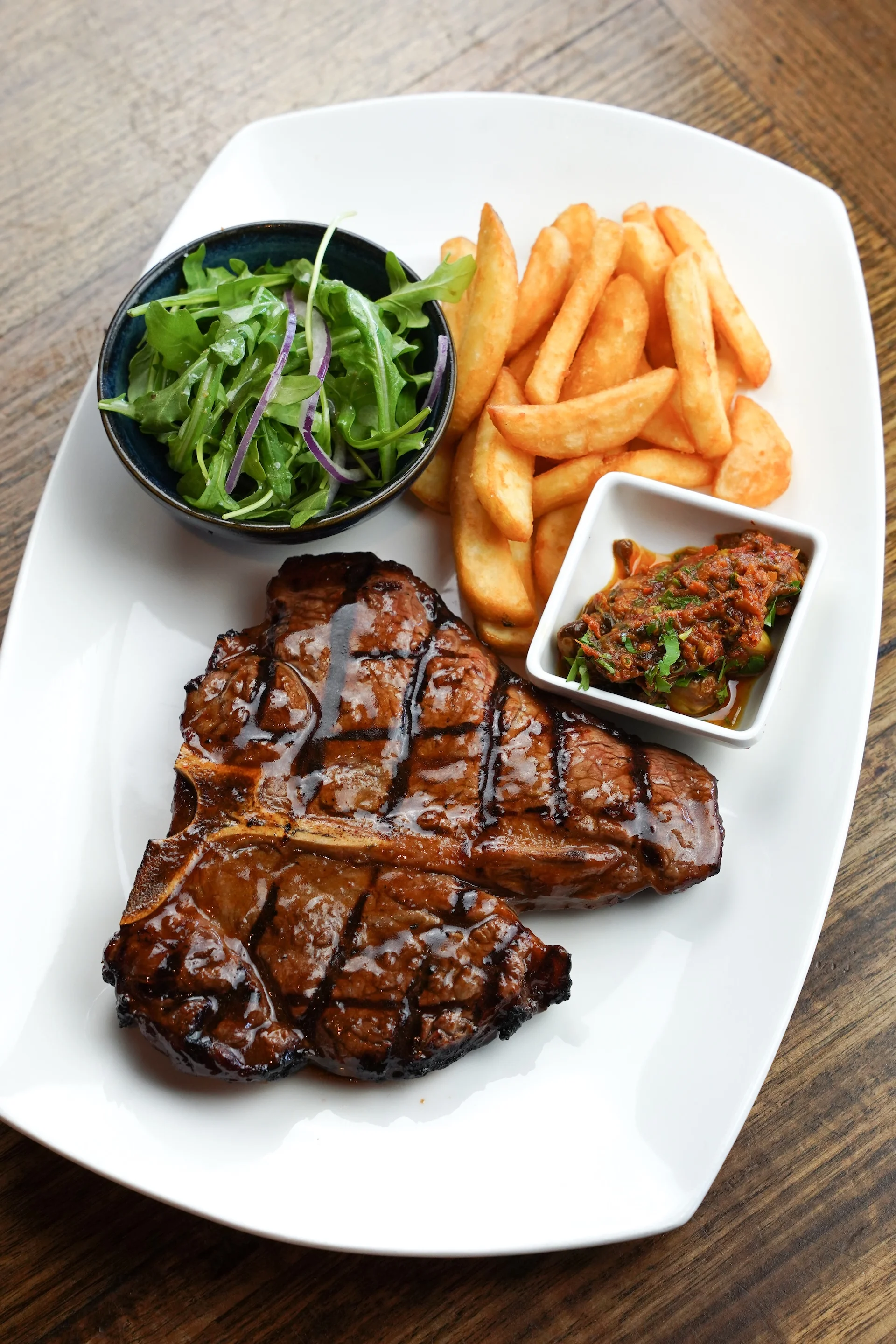 T-bone steak with chips, rocket salad and chimichurri at Waterbar & Grill Steakhouse, Cairns